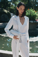 White PODYH YAPRAQ blouse shirt with long sleeves and a classic collar, shown on a hanger.