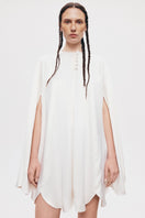 White GUL cape coat by PODYH, featuring a stylish design with a hood and elegant fit, perfect for layered winter fashion.