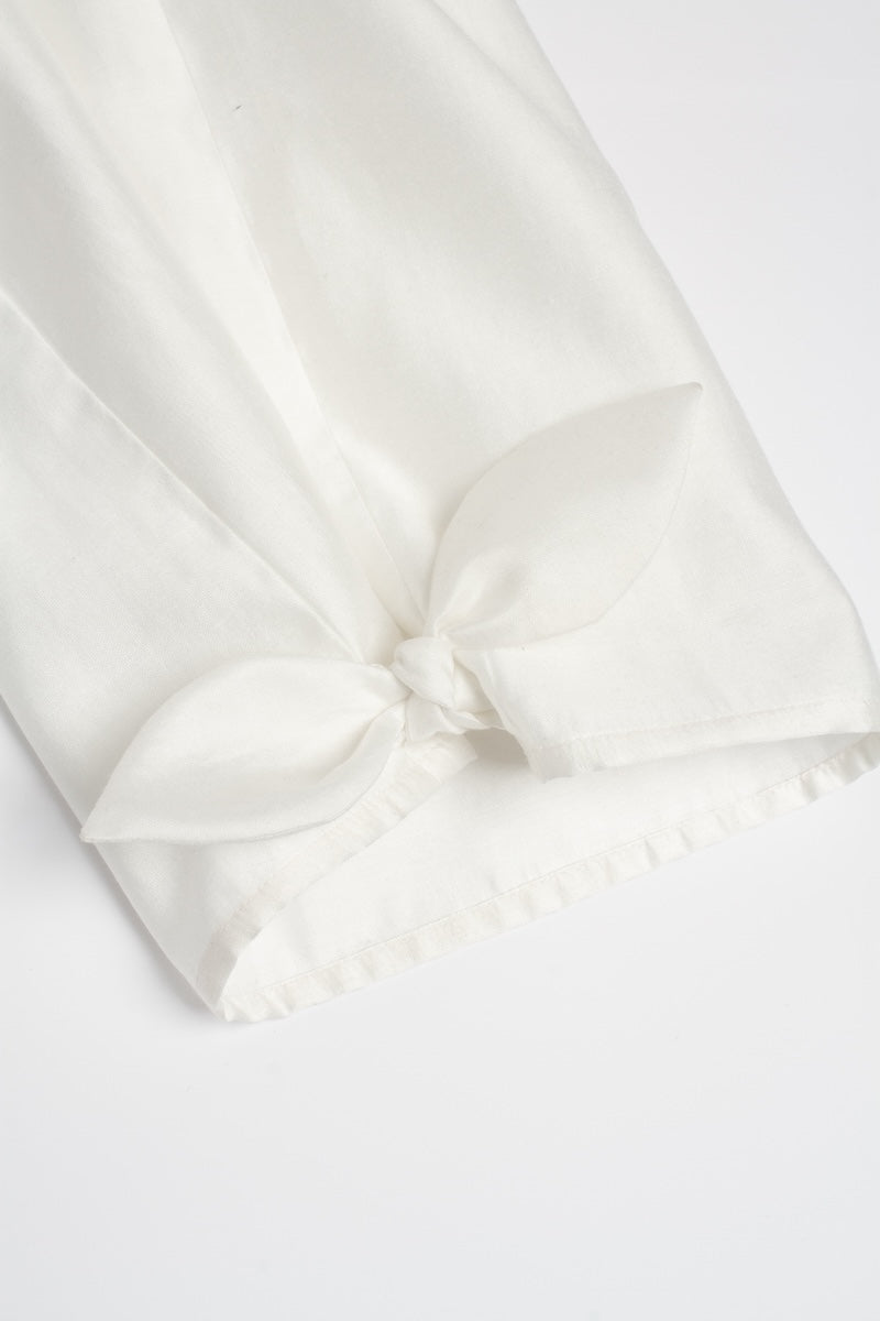 White Shalvar pants by Podyh, featuring traditional loose-fitting design with embroidered details, shown on a model.