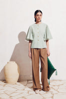 PODYH NAR blouse in green and white, stylish shirt with a relaxed fit, displayed on a hanger.