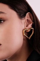 Heart-shaped earrings by Natia x Lako, featuring elegant design and shiny finish, displayed on a neutral background.