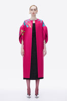 Hand-painted pink coat by Tiny Ink featuring an abstract design, displayed on a hanger against a neutral background.