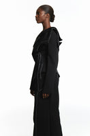 Sean Sheila black deconstructed top with back opening, featuring a stylish, modern design with cut-out detail and unique silhouette.