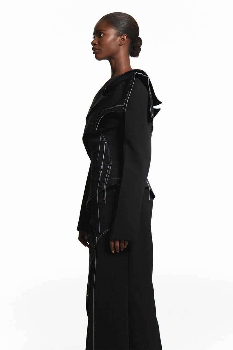 Sean Sheila black deconstructed top with back opening, featuring a stylish, modern design with cut-out detail and unique silhouette.