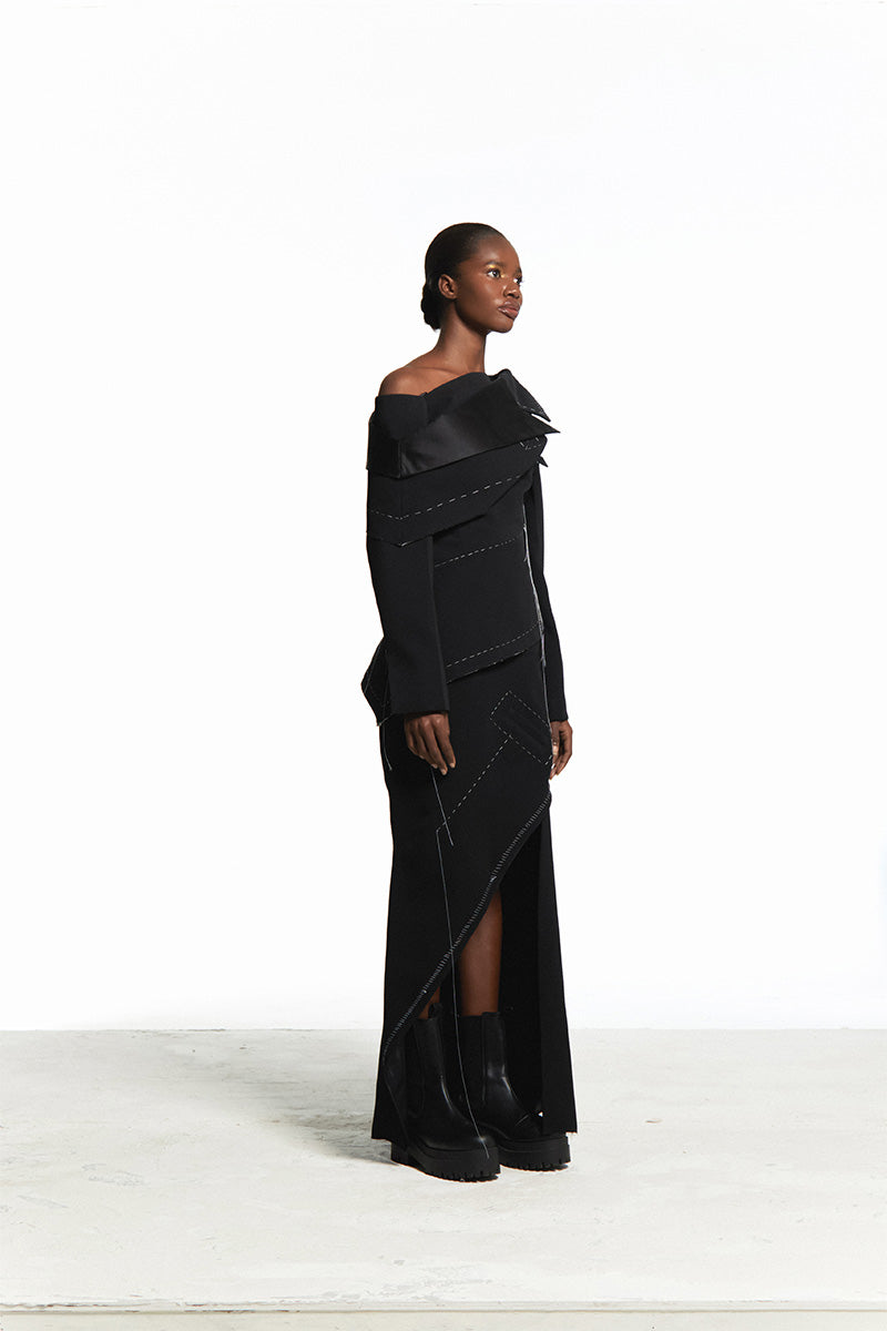 Sean Sheila deconstructed black top with back opening, stylish sleeveless design, shown from the side.