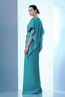 Blue Himalayan Poppy of Tiny Ink maxi dress with floral print, flowing fabric, and sleeveless design on model.