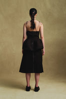 Black balloon hem top by Sean Sheila, featuring a relaxed fit and unique balloon-style sleeves, shown from the back.