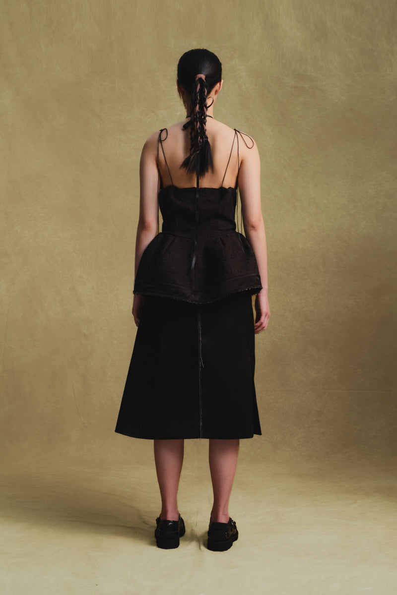Black balloon hem top by Sean Sheila, featuring a relaxed fit and unique balloon-style sleeves, shown from the back.
