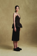 Black balloon hem top by Sean Sheila, shown from the side with a relaxed fit and stylish balloon sleeves.