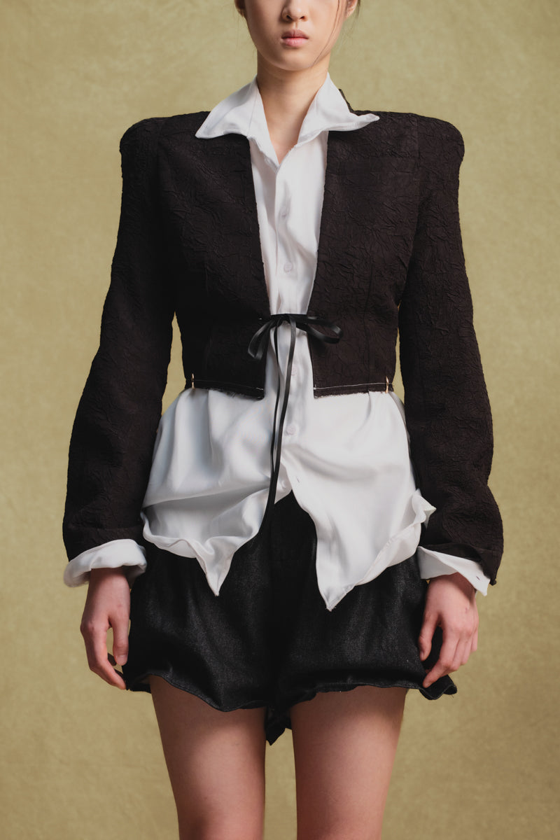 Black crinkled cropped jacket by Sean Sheila, shown in detail with textured fabric and stylish fit.