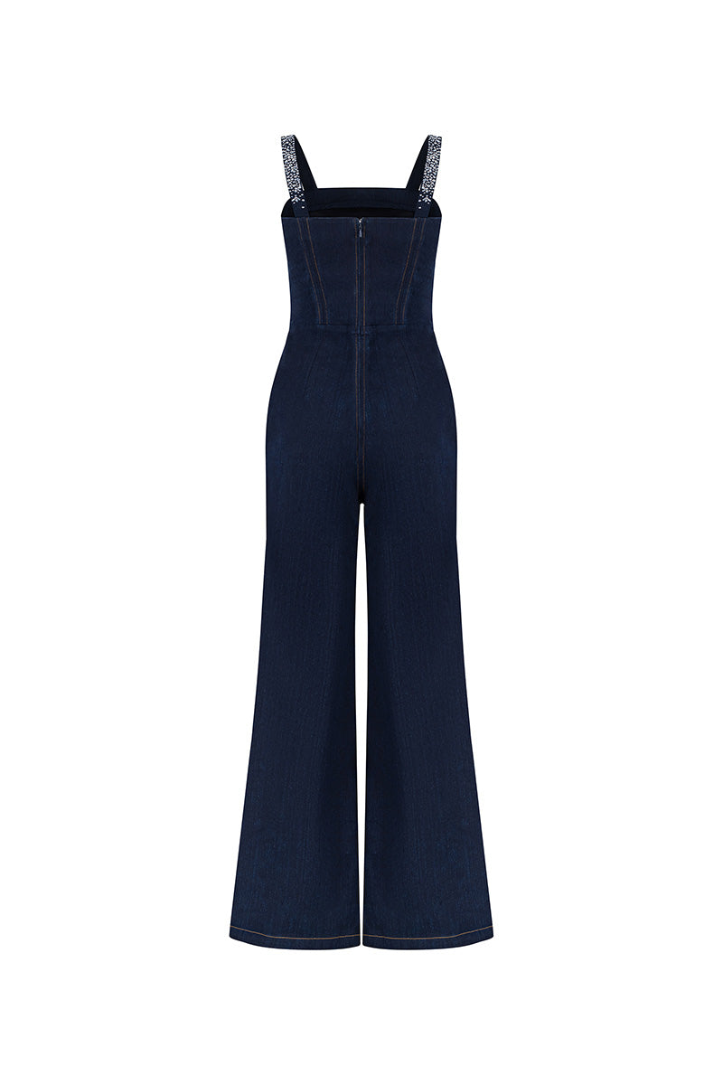 Back view of Lili Blanc blue denim jumpsuit with crystal embellishments, showcasing fitted design and stylish details.
