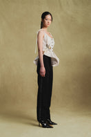 White Jacquard tank top by Sean Sheila, shown from a side view, featuring intricate woven patterns and a sleeveless design.