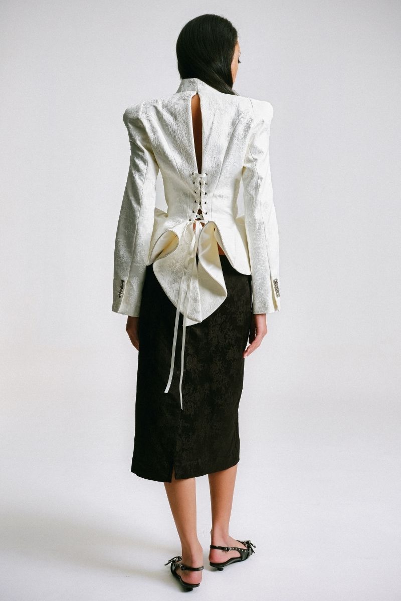 Sean Sheila BESKAP jacket with flared hems, stylish outerwear featuring a tailored fit and dramatic flared sleeve design.