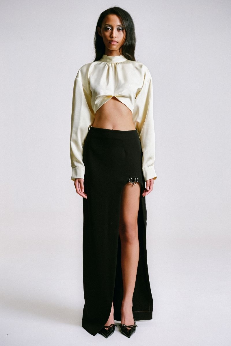 Black Sean Sheila maxi skirt with cut-out slit and piercing detail, featuring a stylish and modern design.