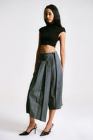 Side view of a women's Sean Sheila cropped corset top, stylish tops with fitted design and adjustable straps.