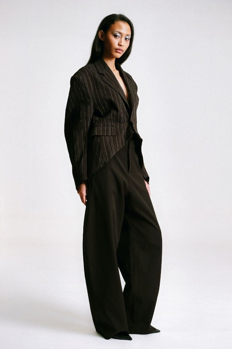 Sean Sheila cowboy pants shown from the side, featuring classic western style with detailed stitching and a rugged denim look.