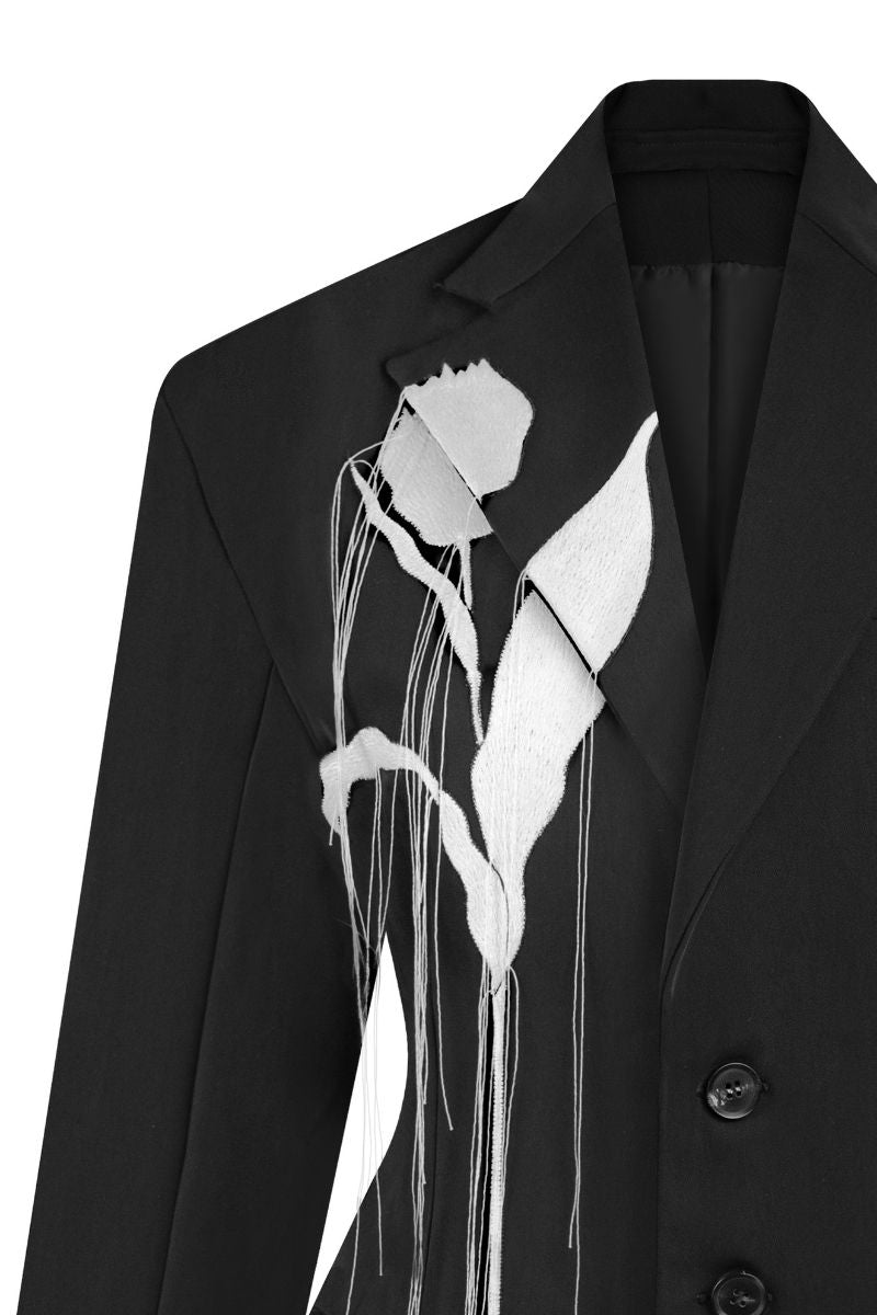 Close-up of Sean Sheila embroidered tailored jacket showing intricate stitching and high-quality fabric details.