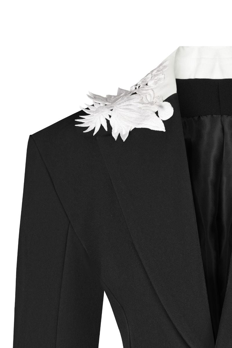 Black tailored suit jacket with embroidered collar by Sean Sheila, featuring sleek design and fine stitching details.
