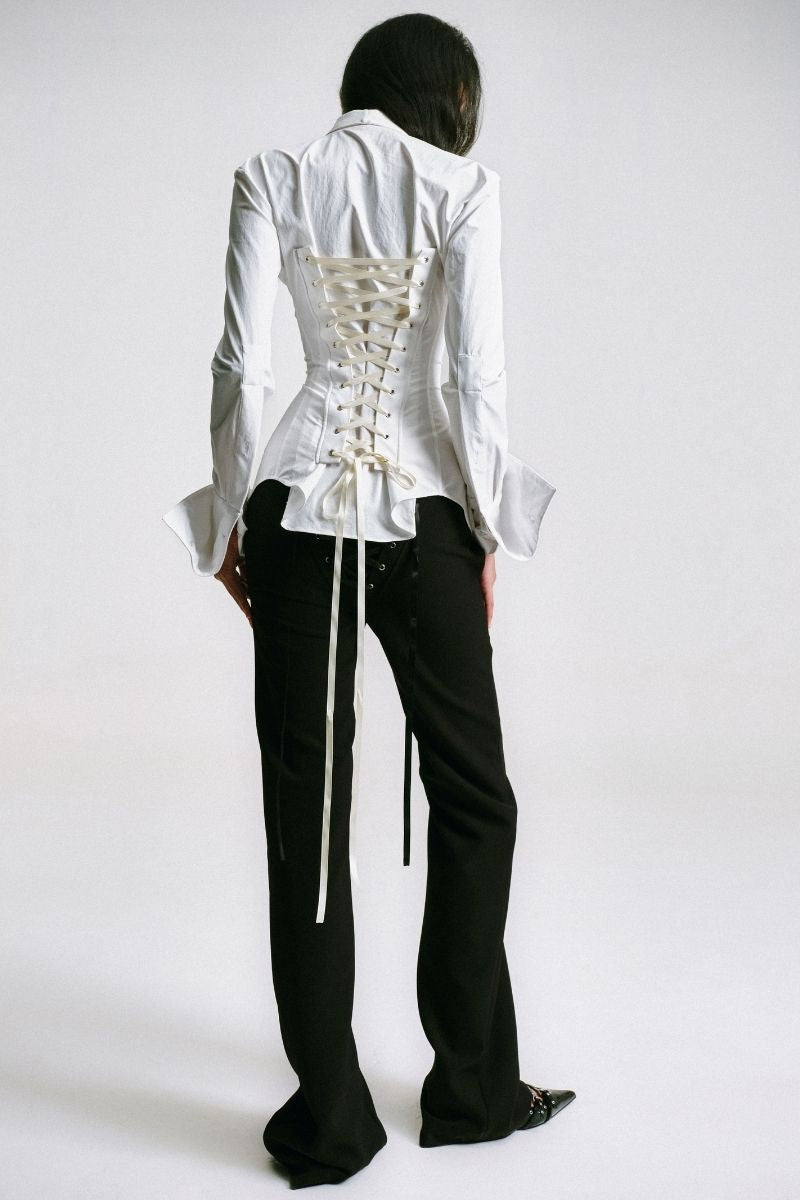 White kebaya shirt with corset detail from Sean Sheila, shown from the back with intricate stitching and tailored fit.