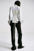 White kebaya shirt with corset detail from Sean Sheila, featuring traditional design and elegant fit, shown from the back.