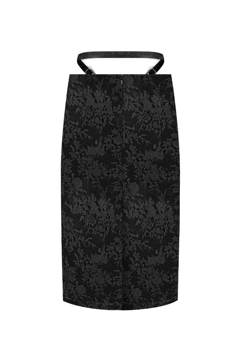 Black midi pencil skirt with stencil detail from Sean Sheila, shown from the back. Elegant, fitted design with stylish pattern accents.