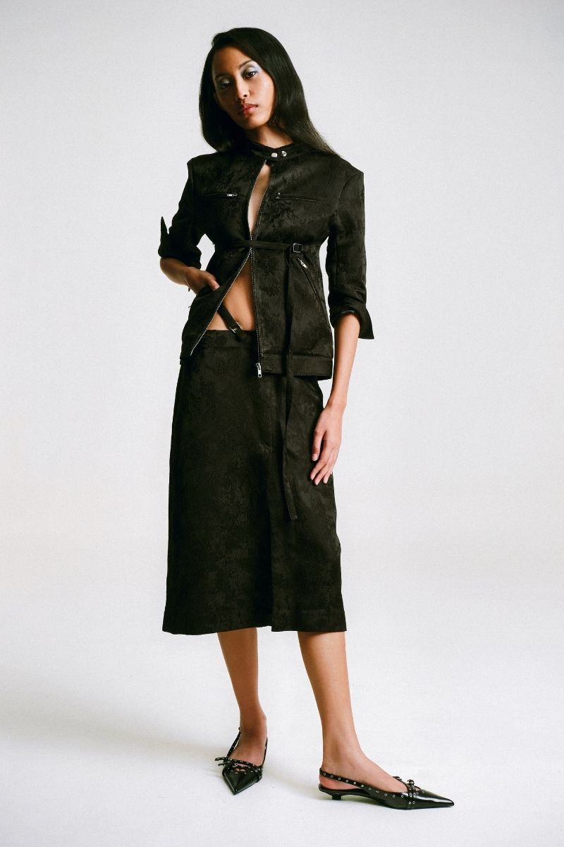 Black midi pencil skirt with stencil detail by Sean Sheila, front view showcasing fitted silhouette and stylish design.