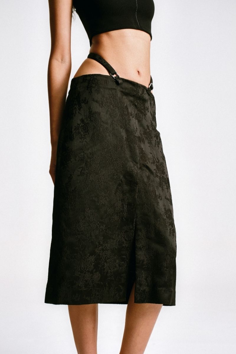 Black midi pencil skirt with stencil detail from Sean Sheila, shown from a side view.