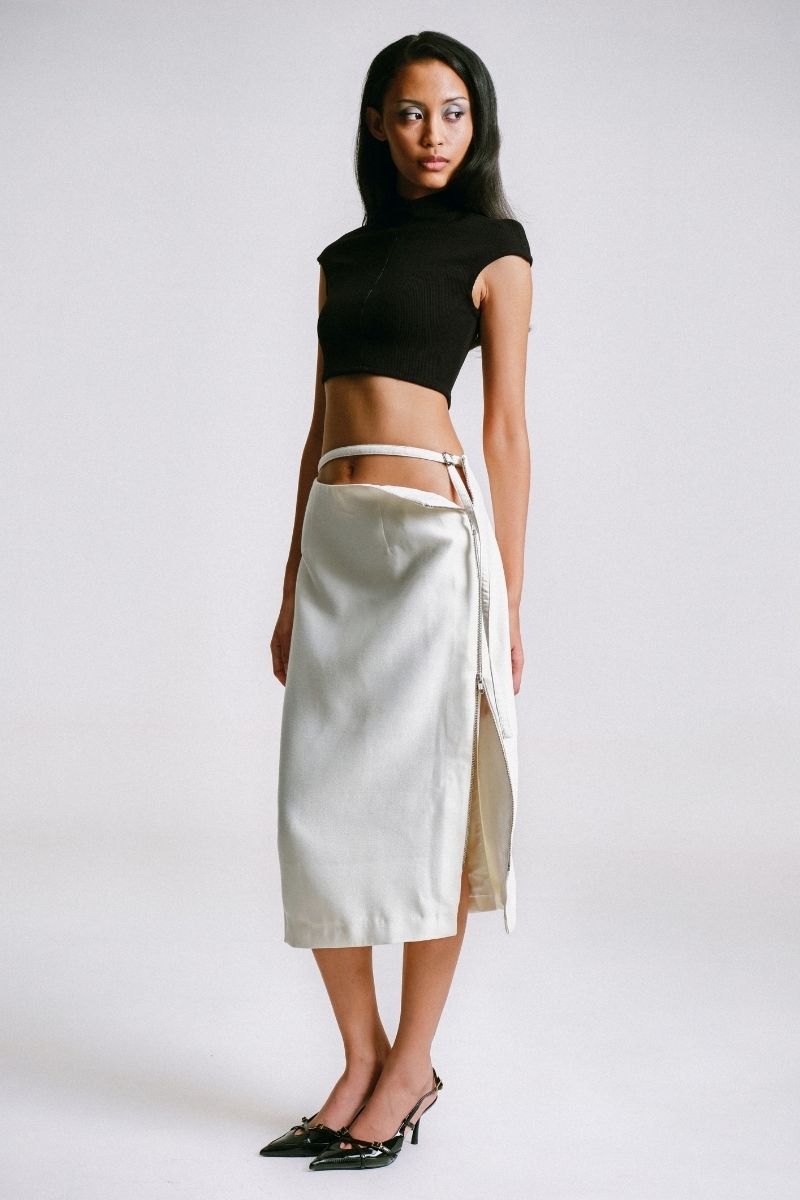 White midi pencil skirt with stencil detail by Sean Sheila, shown from the side view.