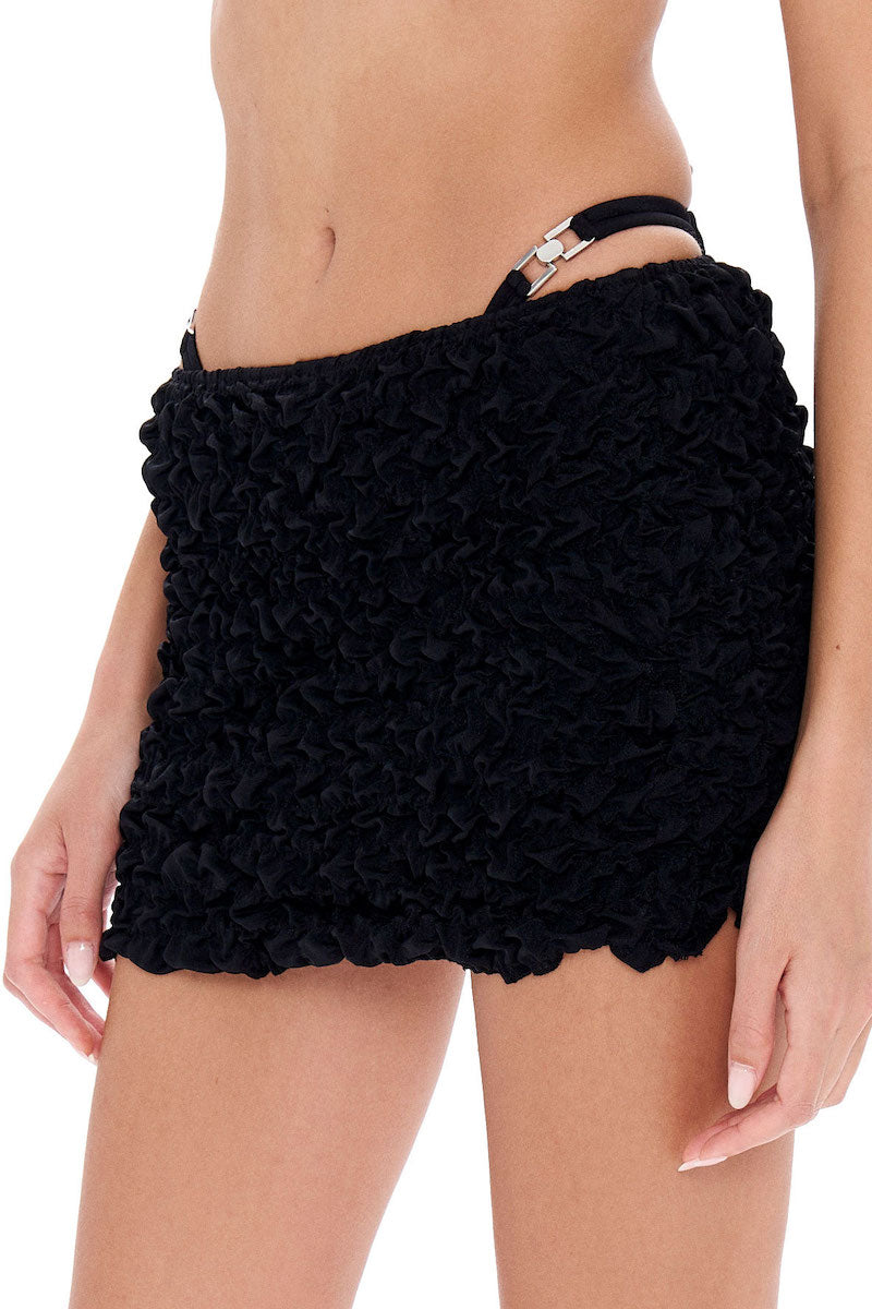 Selia Richwood LIA Black Mini Beach Skirt cover-up with lightweight fabric, styled for beach or poolside wear.