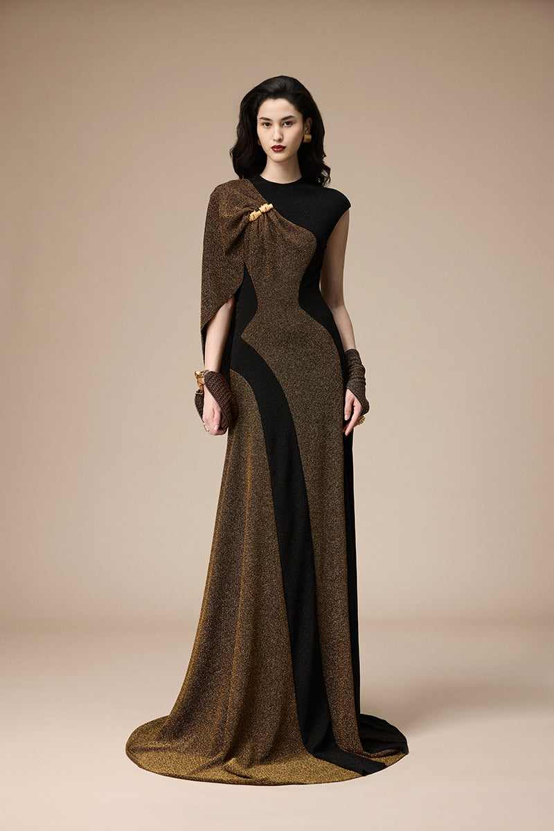 Jenny K Tran Stardust dress in black and gold glitter, elegant gown with shimmering details and flowing fabric.