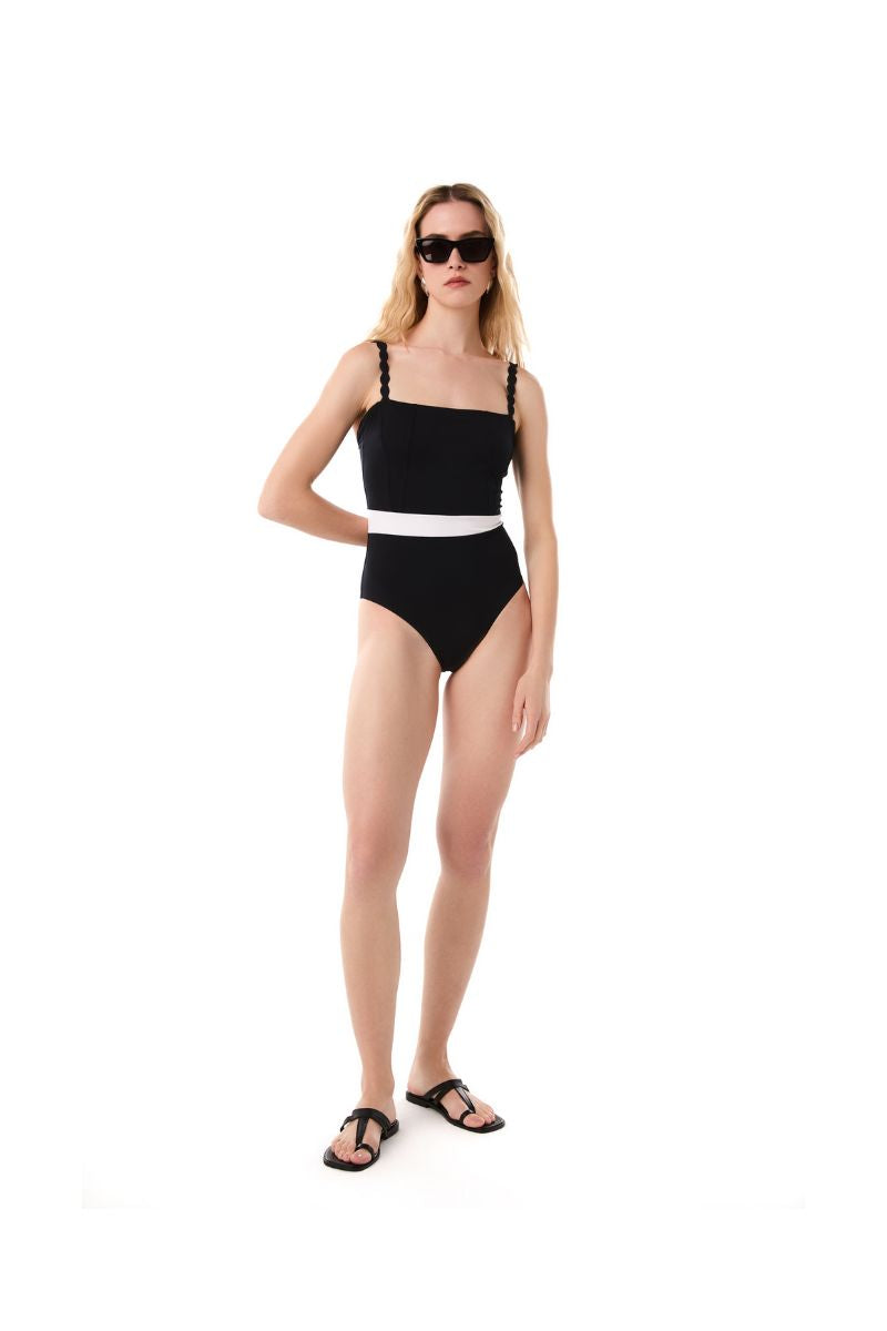Black STEPH swimsuit by KIÓHNE, featuring a sleek, fitted design with adjustable straps, shown on a model.