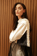 SAC DE SOUL Camila shoulder bag in black and cream with sleek design and contrasting color block style.