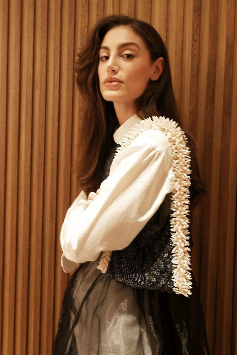 SAC DE SOUL Camila shoulder bag in black and cream with sleek design and contrasting color block style.