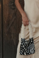 Black, cream, and white butterfly print shoulder bag by SAC DE SOUL featuring a stylish clash of prints design.