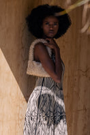 Cream and gold SAC DE SOUL NINA top handle bag with sleek design and elegant gold accents.