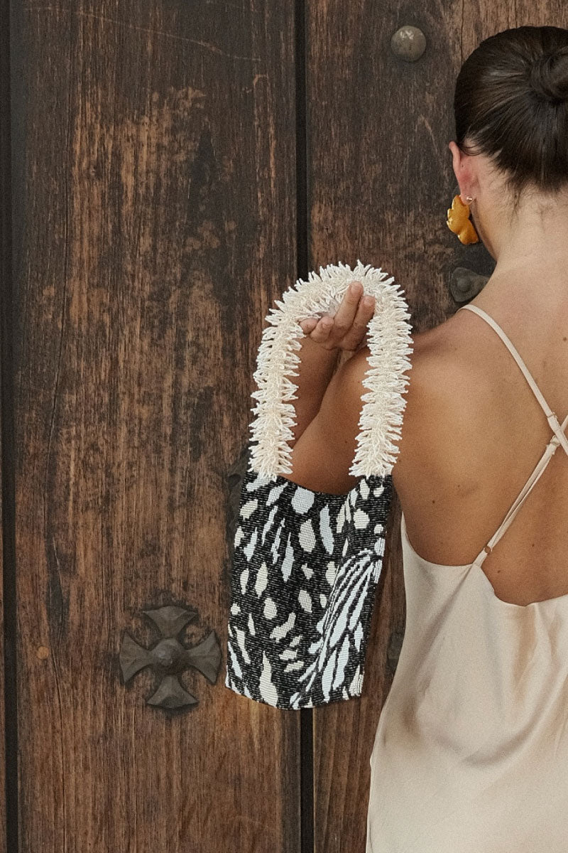 Black, cream, and white butterfly print shoulder bag by SAC DE SOUL featuring a stylish clash of prints design.