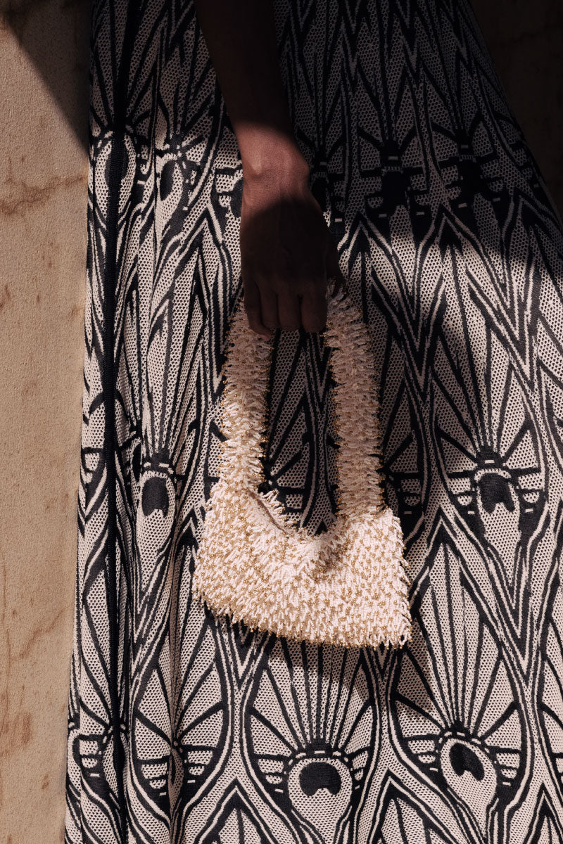 Cream and gold Nina top handle bag by Sac de Soul, stylishly displayed with elegant design and gold accents.