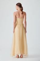 Bright saffron maxi dress by Mastani featuring a strapless design and flowing silhouette, perfect for elegant summer occasions.