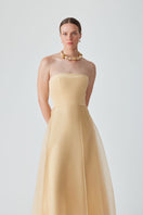 Yellow strapless maxi dress by Mastani featuring a flowing design and elegant silhouette.