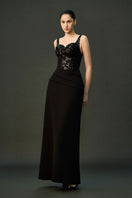 Black ESME gown by EEGEN STUDIO featuring elegant fabric and a flowing design, shown on a model.