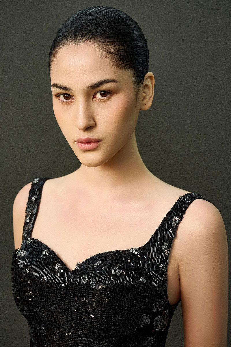Black ESME gown by EEGEN STUDIO, featuring elegant fabric and detailed design, displayed on a hanger.