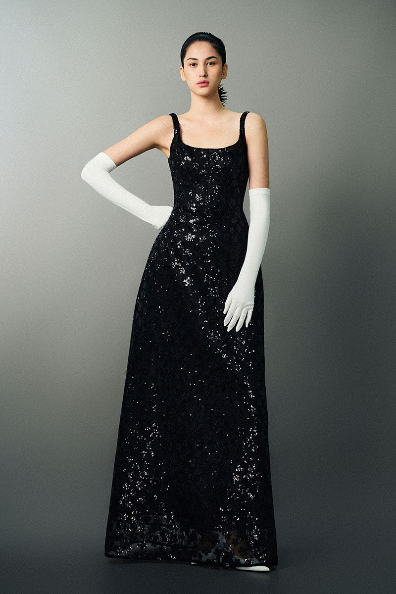 Black Anisa gown by Eegen Studio, elegant floor-length dress with a flowing silhouette and subtle detailing.