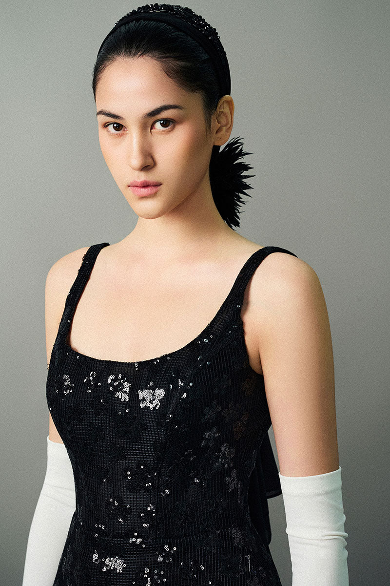 Black Anisa gown by EEGEN STUDIO, elegant evening dress with flowing fabric and intricate detailing.