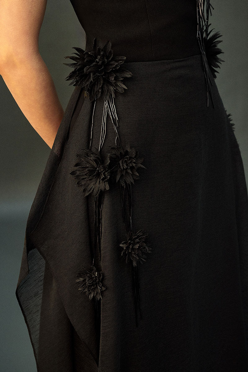 Black shale gown by EEGEN STUDIO featuring a flowing silhouette and elegant design, suitable for formal occasions.