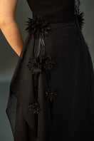 Black shale gown by EEGEN STUDIO featuring a flowing silhouette and elegant design, suitable for formal occasions.