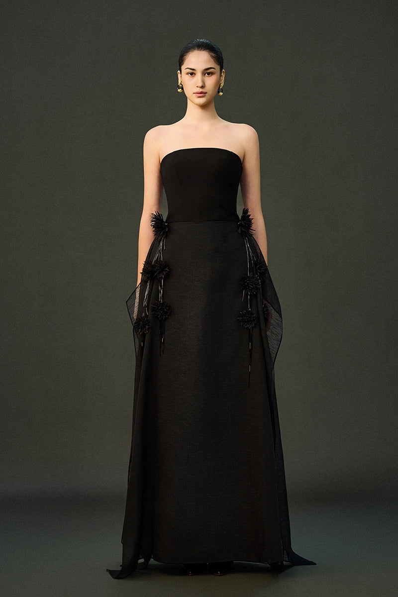 Black shale gown by EEGEN STUDIO, flowing fabric and elegant design, shown on a model with a full-length view.