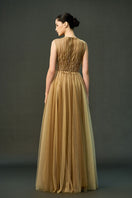 Light brown Noura gown by EEGEN STUDIO, flowing dress with elegant fabric and detailed design, perfect for formal occasions.