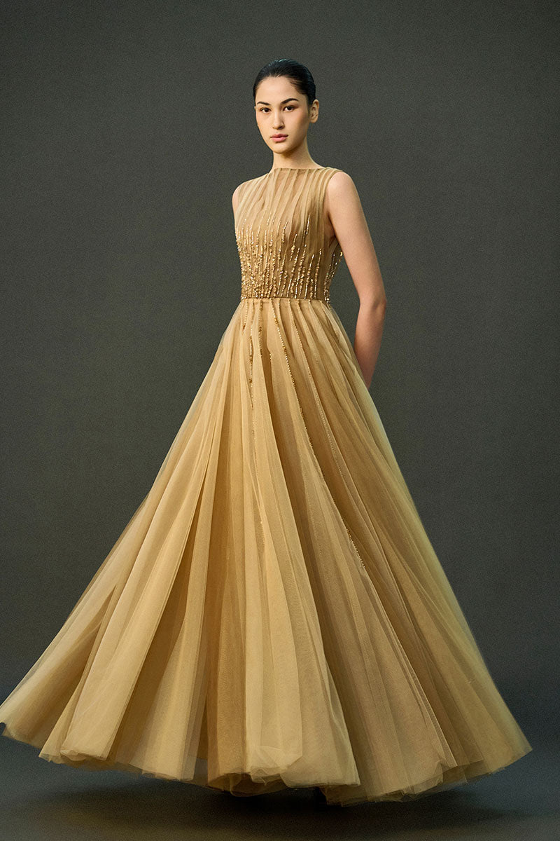 Light brown Noura gown by EEGEN STUDIO, flowing dress with elegant design, displayed on a neutral background.