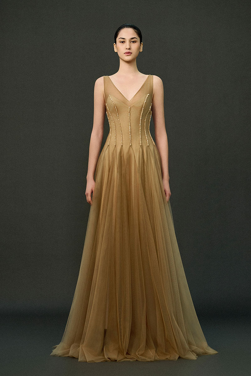 Caramel brown Samara gown by EEGEN STUDIO, elegant floor-length dress with flowing fabric and intricate design details.