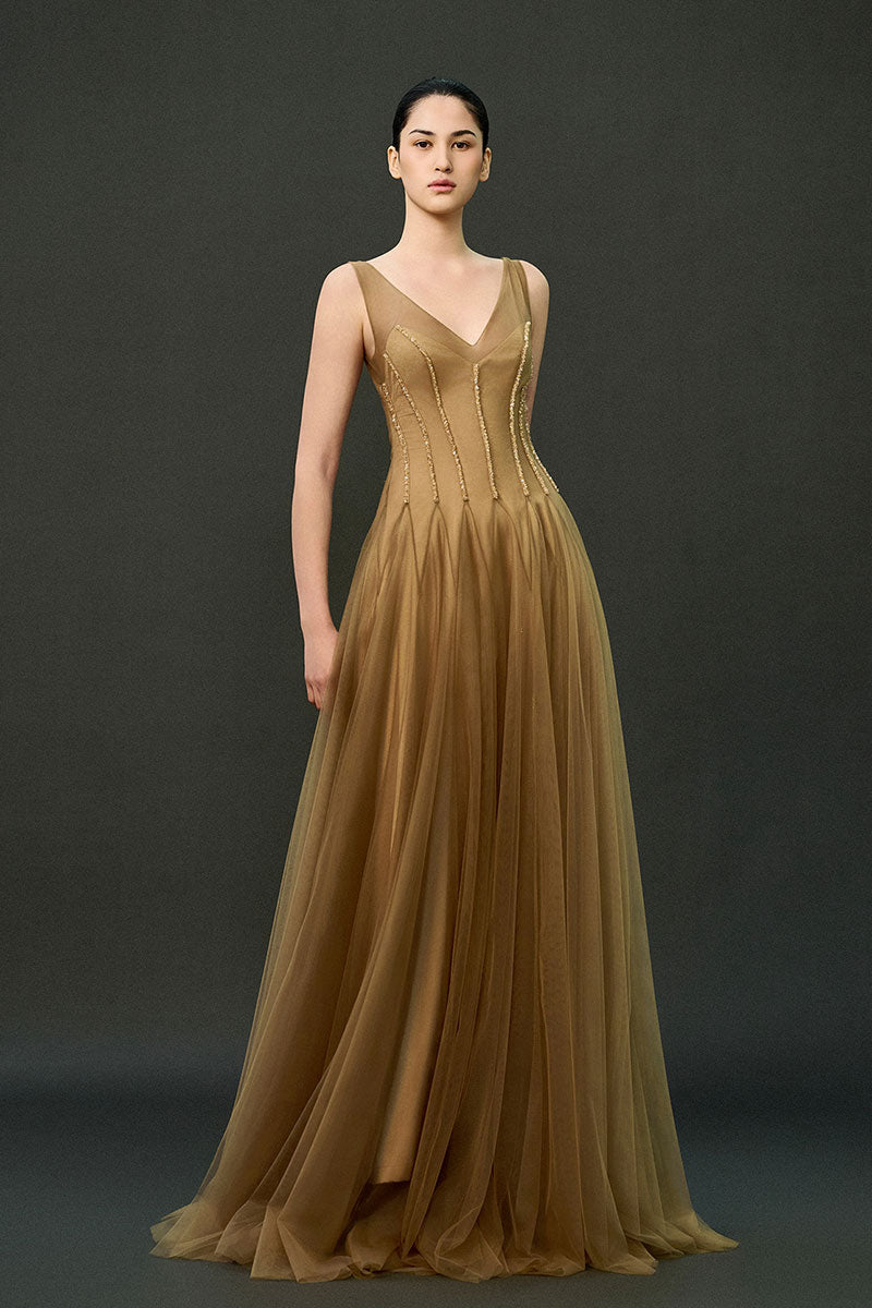 Caramel brown Samara gown by EEGEN STUDIO, elegant floor-length dress with flowing fabric and sophisticated design.